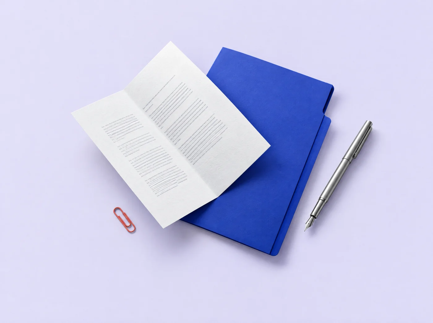 A white document, blue folder and silver pen suspended in a sculptural arrangement